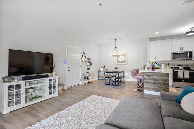 7234 Althorp Way Unit U8, Nashville, TN 37211 - living area featuring light wood-style floors, baseboards, a chandelier, and recessed lighting