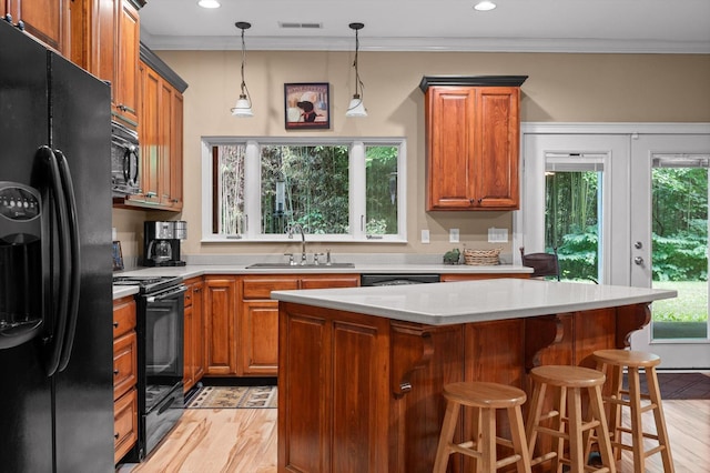 204 Chapman Ct, La Fayette, GA 30728 - kitchen with black appliances, light wood-type flooring, light countertops, brown cabinetry, and ornamental molding