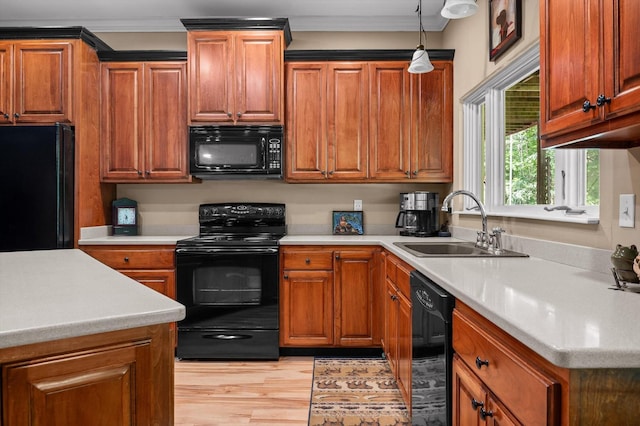 204 Chapman Ct, La Fayette, GA 30728 - kitchen featuring black appliances, a sink, light countertops, light wood finished floors, and pendant lighting