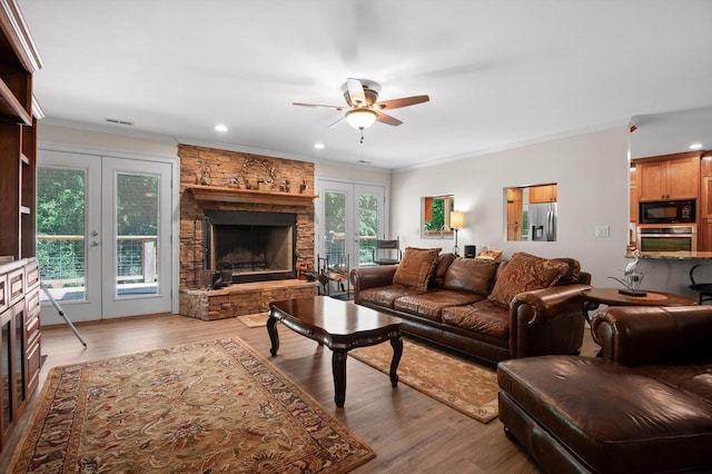 204 Chapman Ct, La Fayette, GA 30728 - living room featuring a fireplace, ceiling fan, french doors, wood finished floors, and ornamental molding