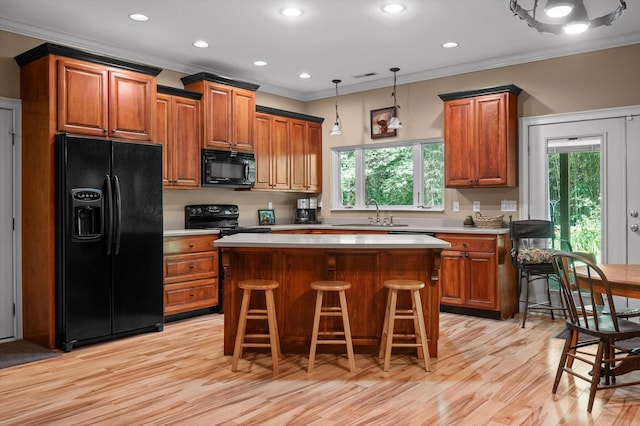 204 Chapman Ct, La Fayette, GA 30728 - kitchen featuring black appliances, crown molding, brown cabinetry, a center island, and light wood-style flooring
