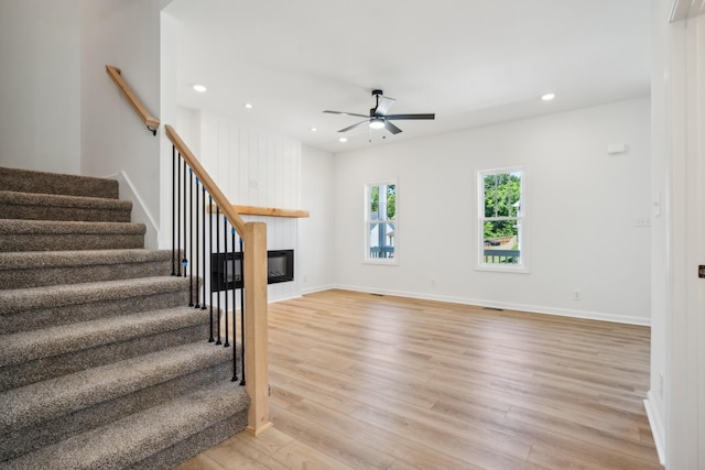 1441 Isaiah Dr, Clarksville, TN 37042 - unfurnished living room with ceiling fan, light wood-type flooring, stairway, a glass covered fireplace, and recessed lighting