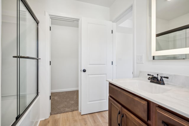 1441 Isaiah Dr, Clarksville, TN 37042 - bathroom featuring vanity, wood finished floors, and enclosed tub / shower combo