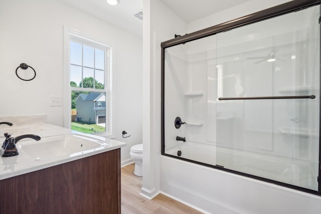 1441 Isaiah Dr, Clarksville, TN 37042 - bathroom featuring vanity, toilet, bath / shower combo with glass door, wood finished floors, and a ceiling fan