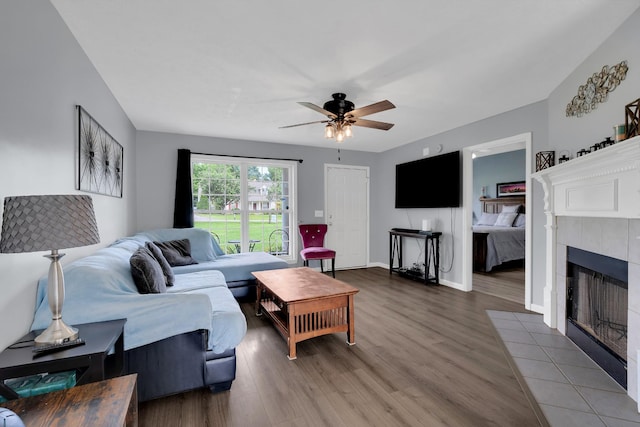 681 Crescent Rd, Murfreesboro, TN 37128 - living area featuring wood finished floors, a ceiling fan, a tiled fireplace, and baseboards