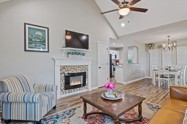 736 Verona Ave, Lewisburg, TN 37091 - living room with wood finished floors, ceiling fan, a chandelier, a glass covered fireplace, and baseboards