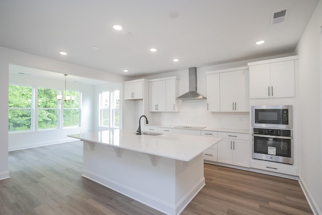 2370 Williamsport Lndg, Columbia, TN 38401 - kitchen featuring wall chimney range hood, stainless steel appliances, a sink, tasteful backsplash, and light countertops