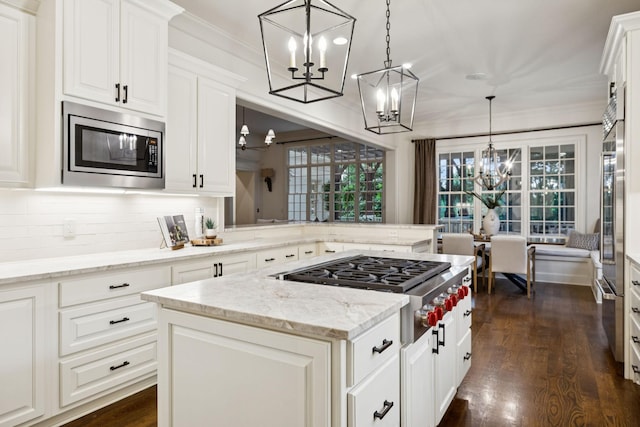 1616 Championship Blvd, Franklin, TN 37064 - kitchen featuring stainless steel appliances, a chandelier, decorative backsplash, a center island, and light stone counters