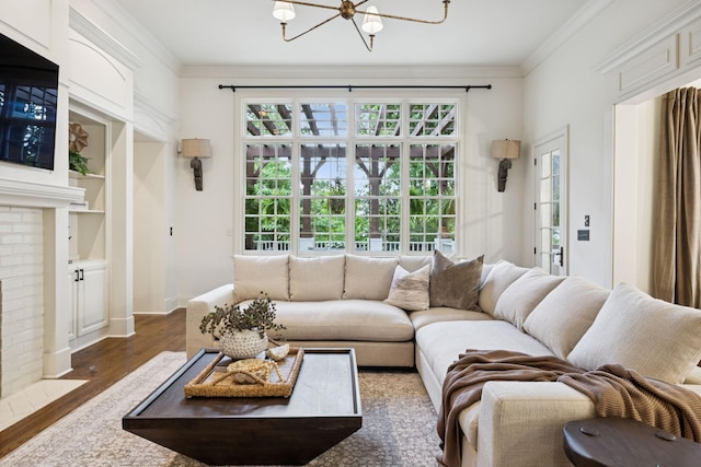 1616 Championship Blvd, Franklin, TN 37064 - living room featuring a chandelier, wood finished floors, ornamental molding, a brick fireplace, and baseboards