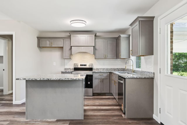 304 S Maple St, Hohenwald, TN 38462 - kitchen with stainless steel appliances, gray cabinetry, a sink, custom range hood, and tasteful backsplash