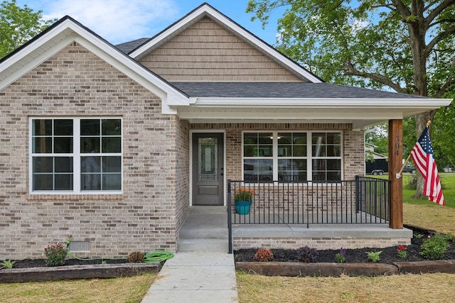 304 S Maple St, Hohenwald, TN 38462 - view of front facade with covered porch, brick siding, roof with shingles, and crawl space