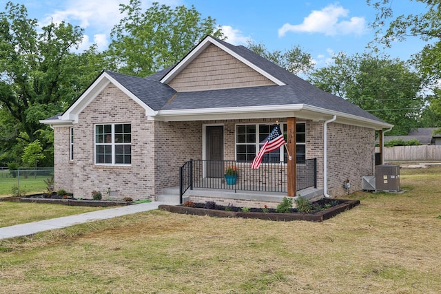 304 S Maple St, Hohenwald, TN 38462 - ranch-style home with cooling unit, brick siding, roof with shingles, a porch, and crawl space