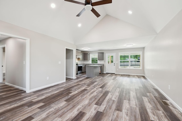 304 S Maple St, Hohenwald, TN 38462 - unfurnished living room featuring ceiling fan, high vaulted ceiling, dark wood-style flooring, recessed lighting, and baseboards