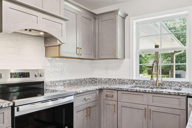 304 S Maple St, Hohenwald, TN 38462 - kitchen with stainless steel electric stove, gray cabinets, a sink, and healthy amount of natural light