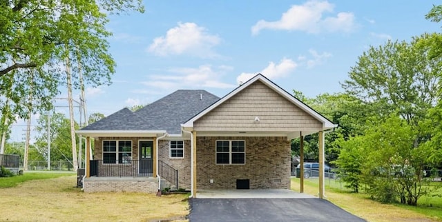304 S Maple St, Hohenwald, TN 38462 - view of front facade with asphalt driveway, brick siding, and a carport