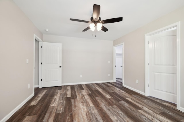 304 S Maple St, Hohenwald, TN 38462 - unfurnished bedroom with dark wood-style flooring, baseboards, and ceiling fan