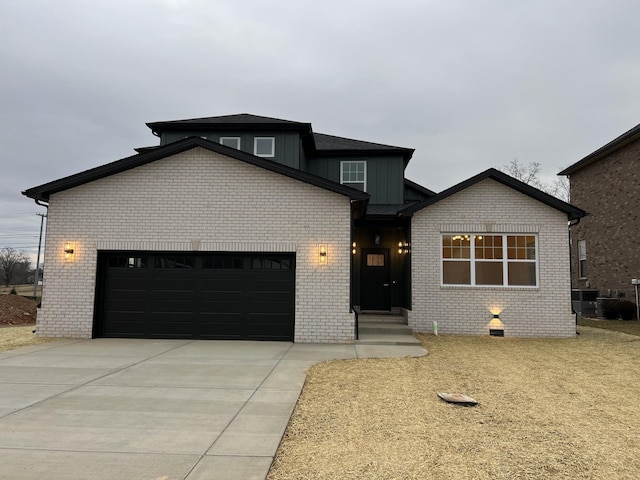 281 Bluebell Dr, Clarksville, TN 37043 - view of front of home with an attached garage, concrete driveway, brick siding, and board and batten siding