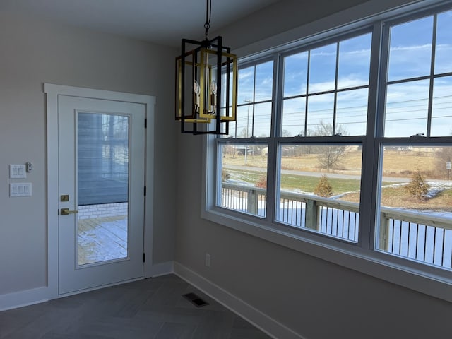 281 Bluebell Dr, Clarksville, TN 37043 - unfurnished dining area with a chandelier and baseboards