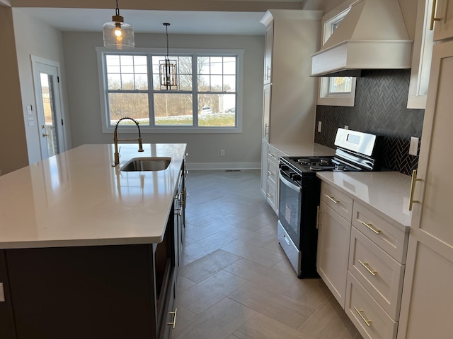 281 Bluebell Dr, Clarksville, TN 37043 - kitchen featuring stainless steel gas stove, custom exhaust hood, a sink, and light countertops