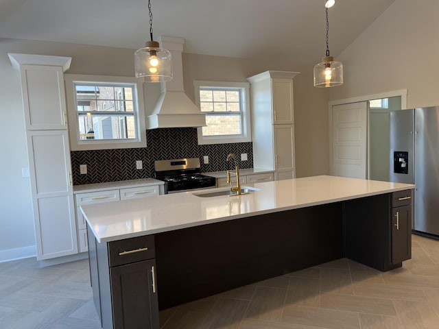281 Bluebell Dr, Clarksville, TN 37043 - kitchen featuring appliances with stainless steel finishes, a sink, light countertops, lofted ceiling, and white cabinetry
