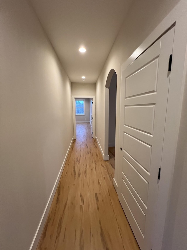 281 Bluebell Dr, Clarksville, TN 37043 - hallway with light wood-type flooring, baseboards, arched walkways, and recessed lighting