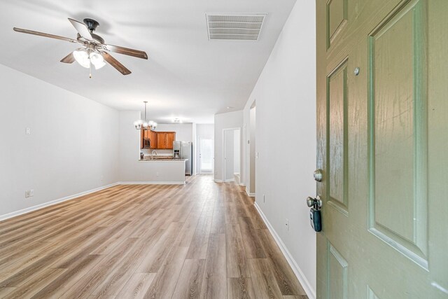 913 Battleview Pl, Murfreesboro, TN 37128 - unfurnished living room with a chandelier, ceiling fan, light wood-type flooring, and baseboards