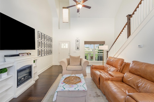 201 Hart Ln, Lebanon, TN 37087 - living room with high vaulted ceiling, a ceiling fan, dark wood-style floors, stairs, and a glass covered fireplace