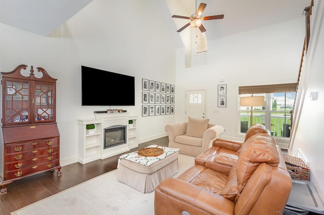 201 Hart Ln, Lebanon, TN 37087 - living area with high vaulted ceiling, a ceiling fan, dark wood-style floors, baseboards, and a glass covered fireplace
