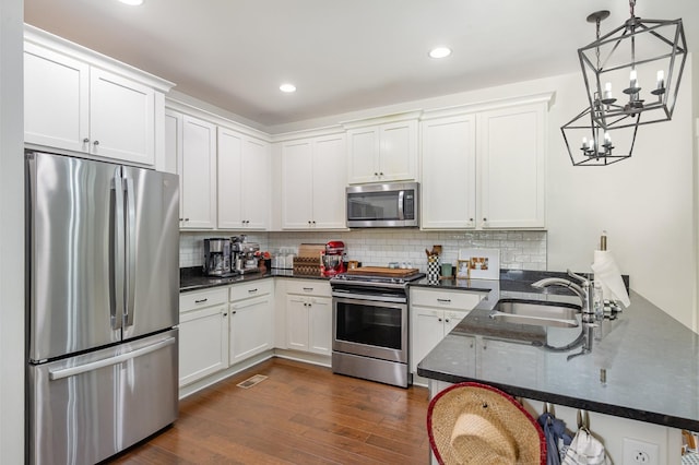 201 Hart Ln, Lebanon, TN 37087 - kitchen featuring appliances with stainless steel finishes, a peninsula, white cabinetry, and recessed lighting