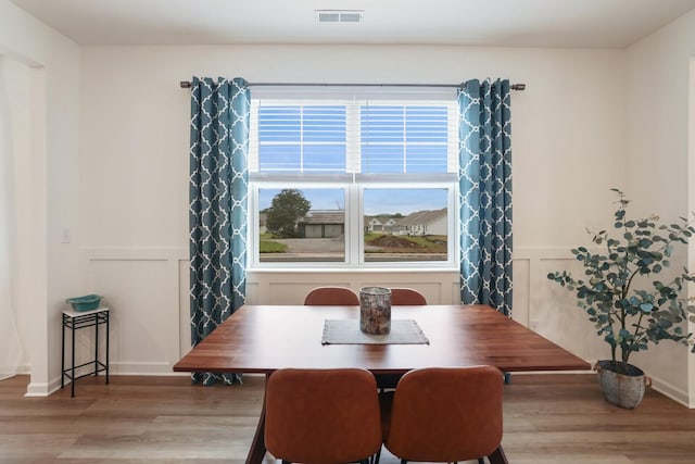 425 Multrees Pl, Smyrna, TN 37167 - dining space with light wood-style floors, a decorative wall, and wainscoting
