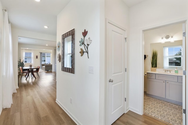 425 Multrees Pl, Smyrna, TN 37167 - hall with healthy amount of natural light, light wood-type flooring, a sink, baseboards, and recessed lighting