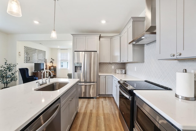 425 Multrees Pl, Smyrna, TN 37167 - kitchen featuring appliances with stainless steel finishes, wall chimney range hood, a sink, gray cabinetry, and light countertops
