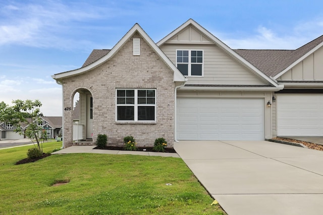 425 Multrees Pl, Smyrna, TN 37167 - view of front facade with board and batten siding, a front lawn, roof with shingles, concrete driveway, and brick siding