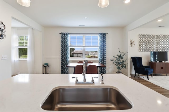 425 Multrees Pl, Smyrna, TN 37167 - kitchen with a sink, recessed lighting, wood finished floors, light countertops, and wainscoting