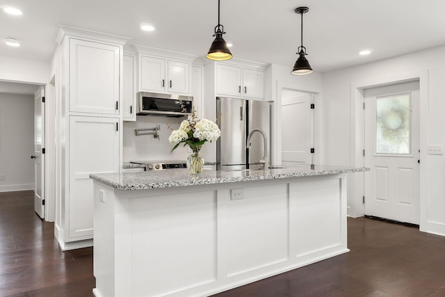 1508 Barnes Dr, Cookeville, TN 38501 - kitchen featuring appliances with stainless steel finishes, white cabinetry, dark wood finished floors, backsplash, and light stone counters