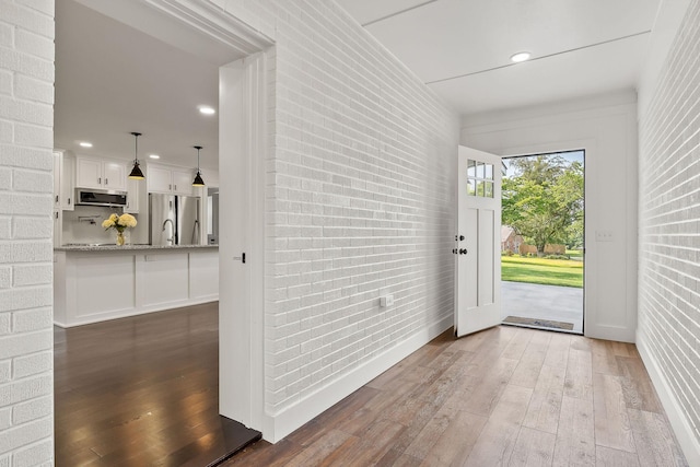 1508 Barnes Dr, Cookeville, TN 38501 - doorway featuring brick wall, hardwood / wood-style floors, recessed lighting, and baseboards