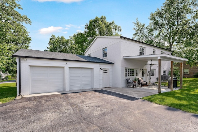 1508 Barnes Dr, Cookeville, TN 38501 - view of front of home featuring asphalt driveway, a garage, brick siding, a ceiling fan, and a patio area
