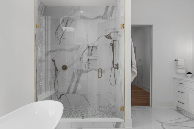 609 Bowling Ave, Nashville, TN 37215 - bathroom featuring marble finish flooring, a marble finish shower, a freestanding tub, and baseboards
