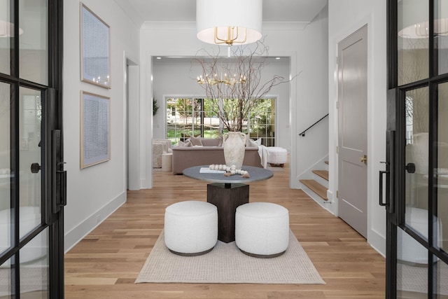 609 Bowling Ave, Nashville, TN 37215 - entryway with stairway, light wood-style floors, a chandelier, crown molding, and baseboards
