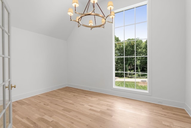 609 Bowling Ave, Nashville, TN 37215 - unfurnished dining area featuring a chandelier, light wood-style flooring, baseboards, and vaulted ceiling
