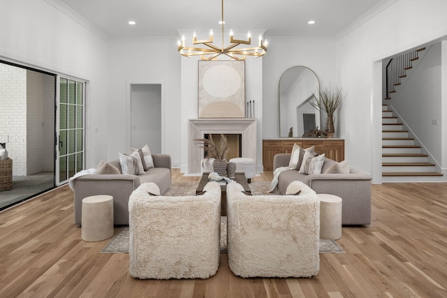 609 Bowling Ave, Nashville, TN 37215 - living room with a fireplace, stairway, a chandelier, wood finished floors, and crown molding