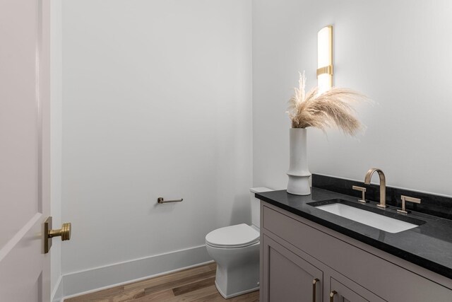 609 Bowling Ave, Nashville, TN 37215 - half bathroom featuring toilet, vanity, wood finished floors, and baseboards