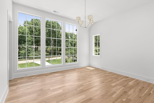 609 Bowling Ave, Nashville, TN 37215 - spare room with a chandelier, healthy amount of natural light, and light wood-style floors