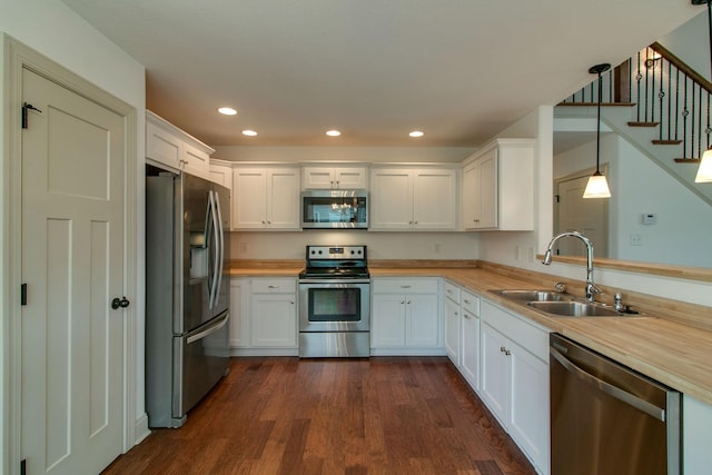 1146 Garrettsburg Rd, Clarksville, TN 37042 - kitchen featuring appliances with stainless steel finishes, a sink, dark wood-style floors, white cabinets, and recessed lighting