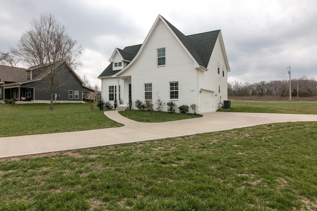 1146 Garrettsburg Rd, Clarksville, TN 37042 - view of front facade with a garage, driveway, central air condition unit, and a front lawn