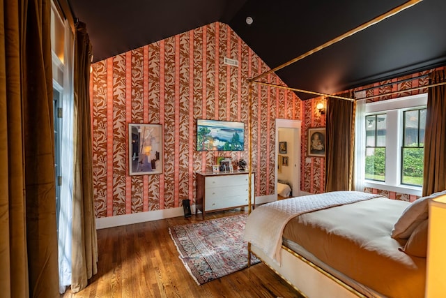 1702 Stokes Ln, Nashville, TN 37215 - bedroom featuring vaulted ceiling, wallpapered walls, and wood finished floors