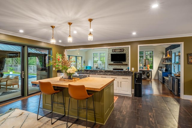 1702 Stokes Ln, Nashville, TN 37215 - kitchen featuring butcher block countertops, plenty of natural light, a center island, a kitchen breakfast bar, and recessed lighting