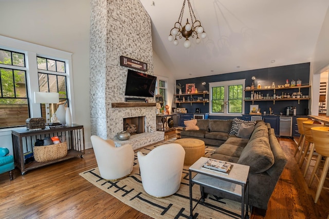 1702 Stokes Ln, Nashville, TN 37215 - living area with high vaulted ceiling, a bar, wood finished floors, and a fireplace