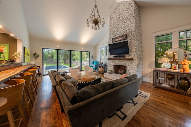 1702 Stokes Ln, Nashville, TN 37215 - living room with high vaulted ceiling, wood finished floors, a fireplace, and a chandelier