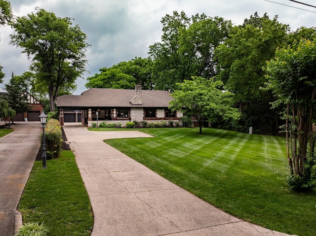 1702 Stokes Ln, Nashville, TN 37215 - view of front facade featuring stone siding, a front yard, driveway, and a chimney